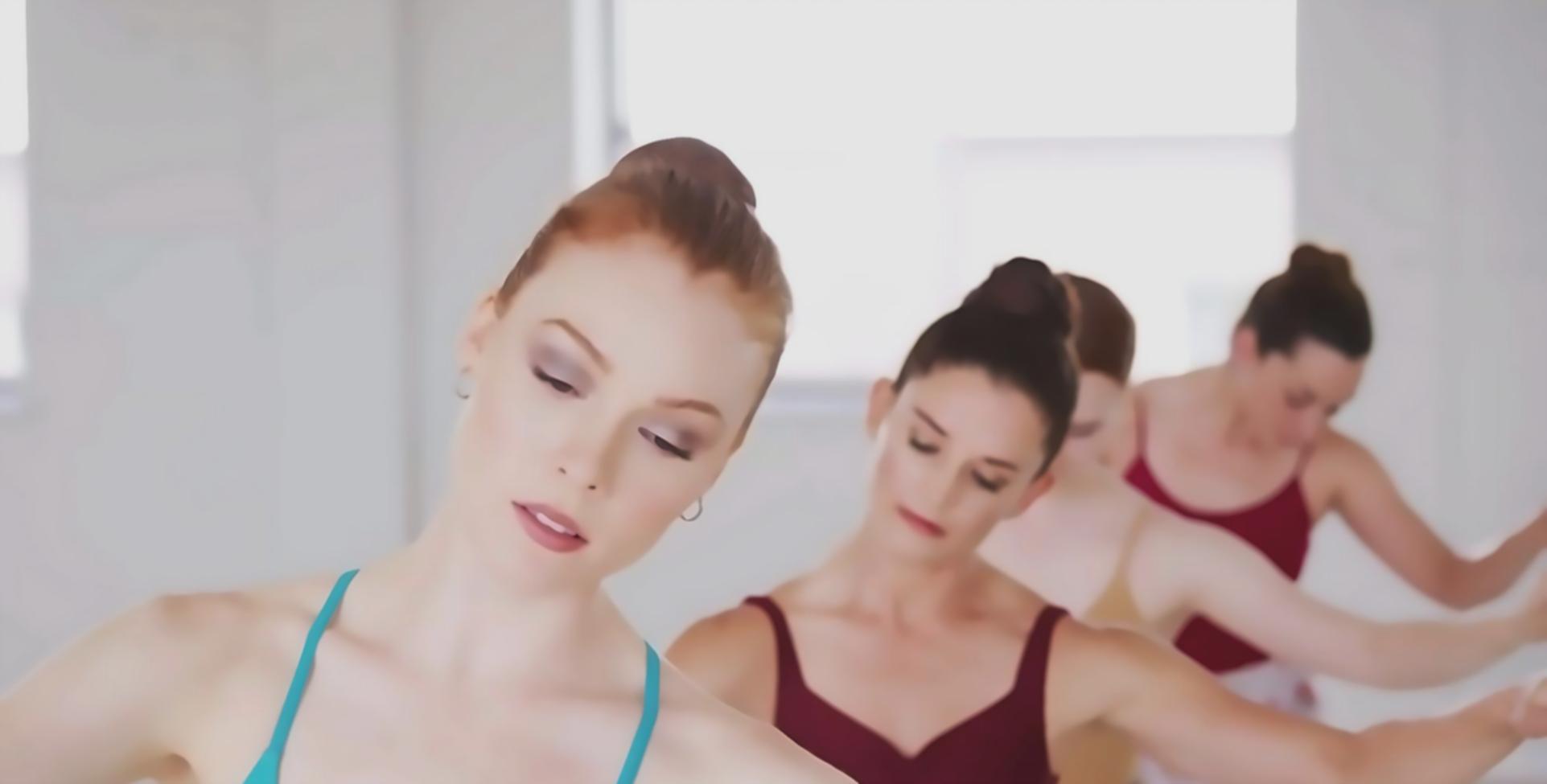 Jazz dance training session showing instructor working with student on movement technique and body positioning